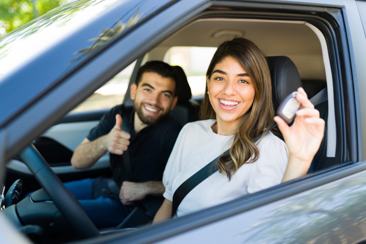 Latin couple taking their new car for a ride